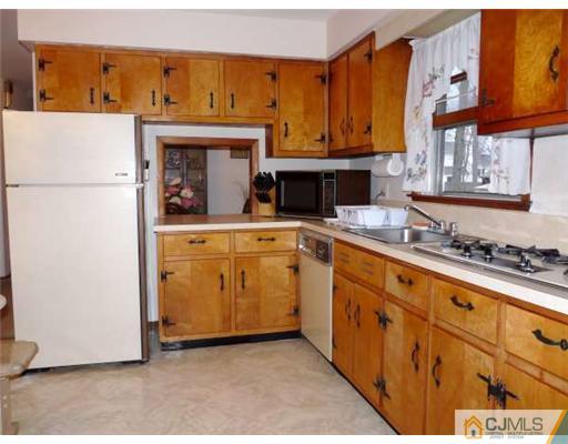 83 Stony Road Edison, NJ 08817 - Photo 4 of 11 a kitchen with granite countertop a sink and a stove
