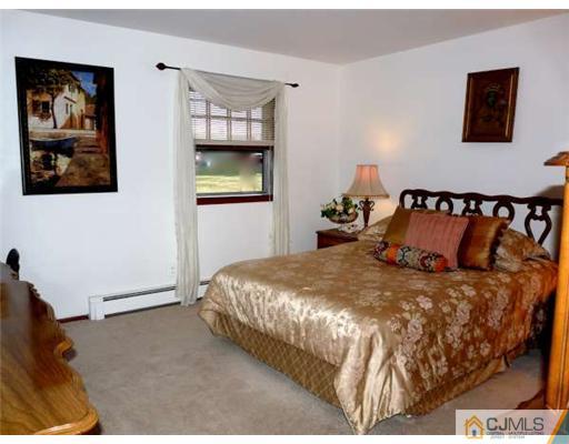83 Stony Road Edison, NJ 08817 - Photo 5 of 11 a bed sitting in a bedroom next to a window