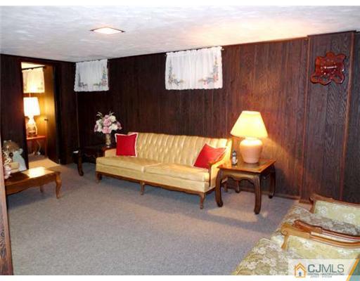 83 Stony Road Edison, NJ 08817 - Photo 9 of 11 a living room with furniture and a fireplace