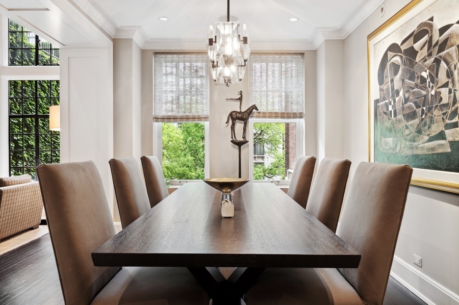 20 East Cedar Street, Unit 4D Chicago, IL 60611 - Photo 13 of 29 a view of a dining room with furniture wooden floor and chandelier