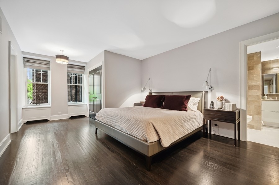 20 East Cedar Street, Unit 4D Chicago, IL 60611 - Photo 18 of 29 a bedroom with a bed and wooden floor