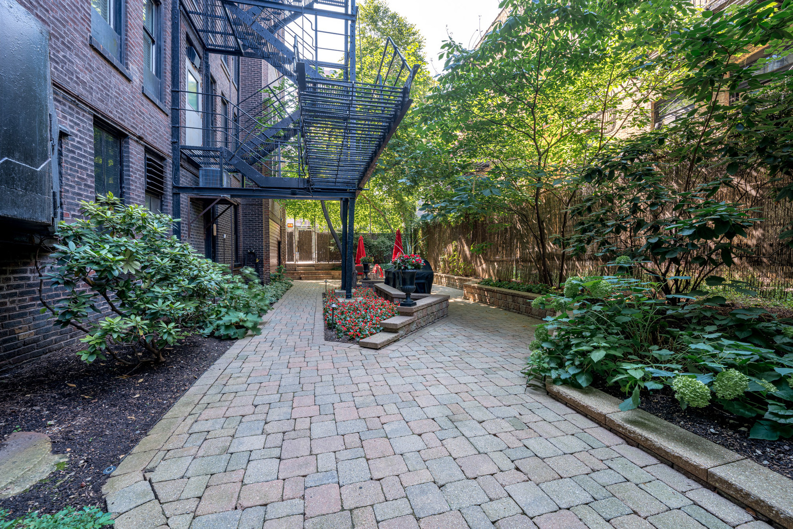 20 East Cedar Street, Unit 4D Chicago, IL 60611 - Photo 27 of 29 a view of a patio with table and chairs potted plants and large tree