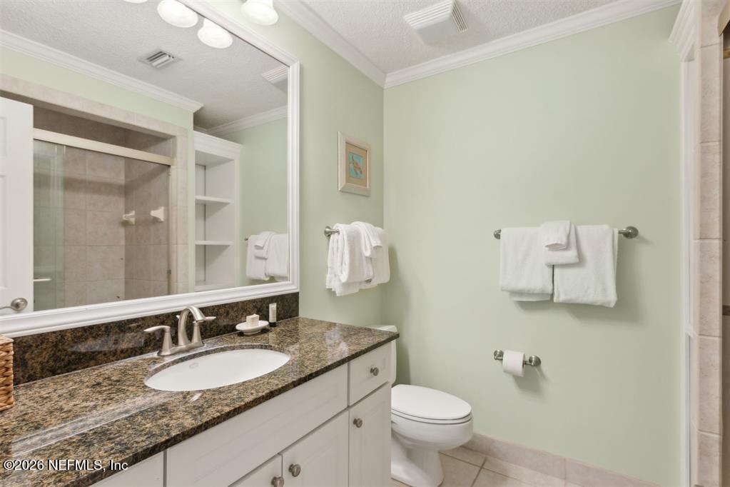 3328 Sea Marsh Road Fernandina Beach, FL 32034 - Photo 25 of 43 a bathroom with a granite countertop sink a large mirror and a toilet