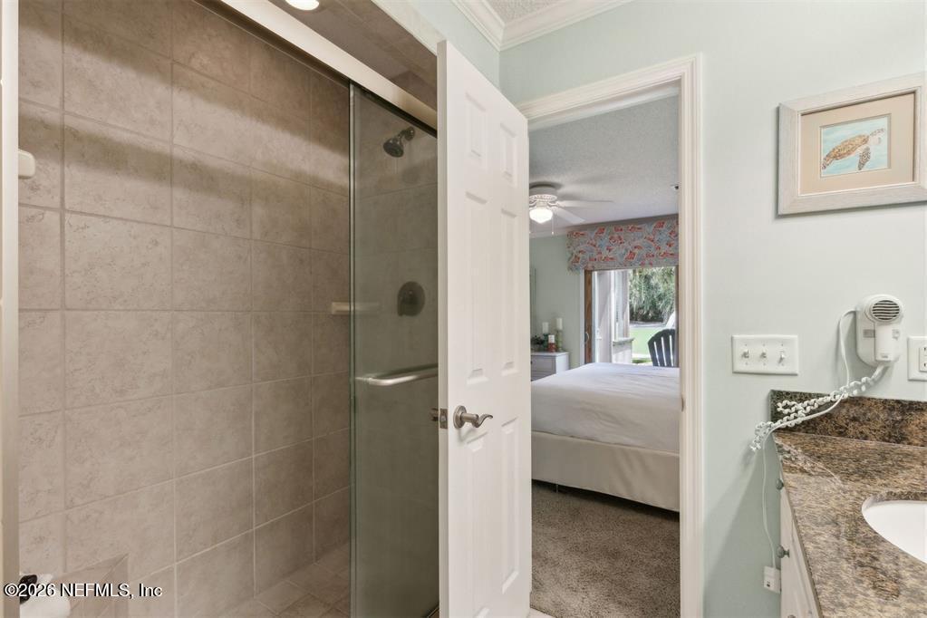 3328 Sea Marsh Road Fernandina Beach, FL 32034 - Photo 26 of 43 a en suite bathroom with a sink a mirror and a shower