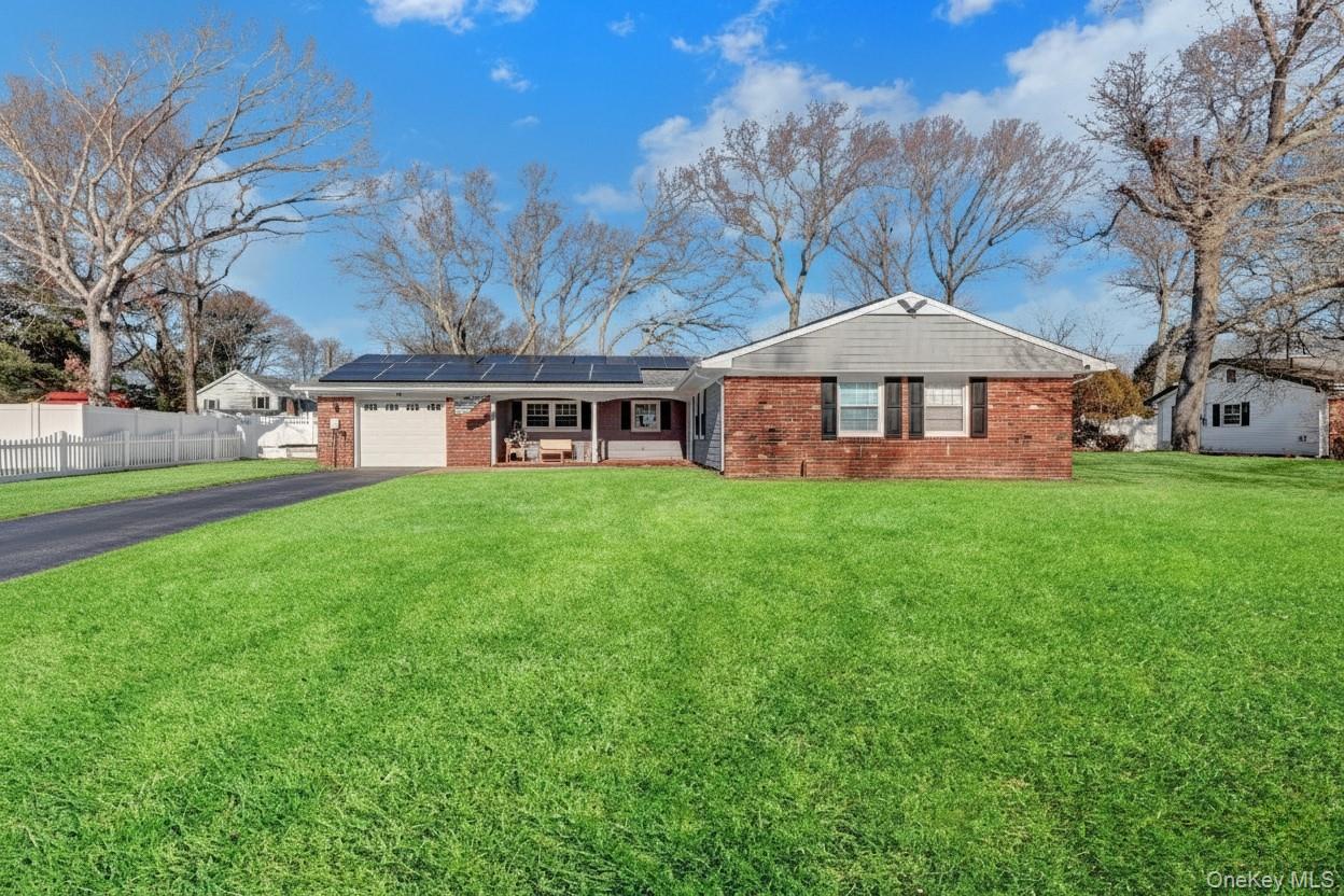 15 Whitmore Lane Coram, NY 11727 - Photo 1 of 10 a view of a house with a yard and large trees