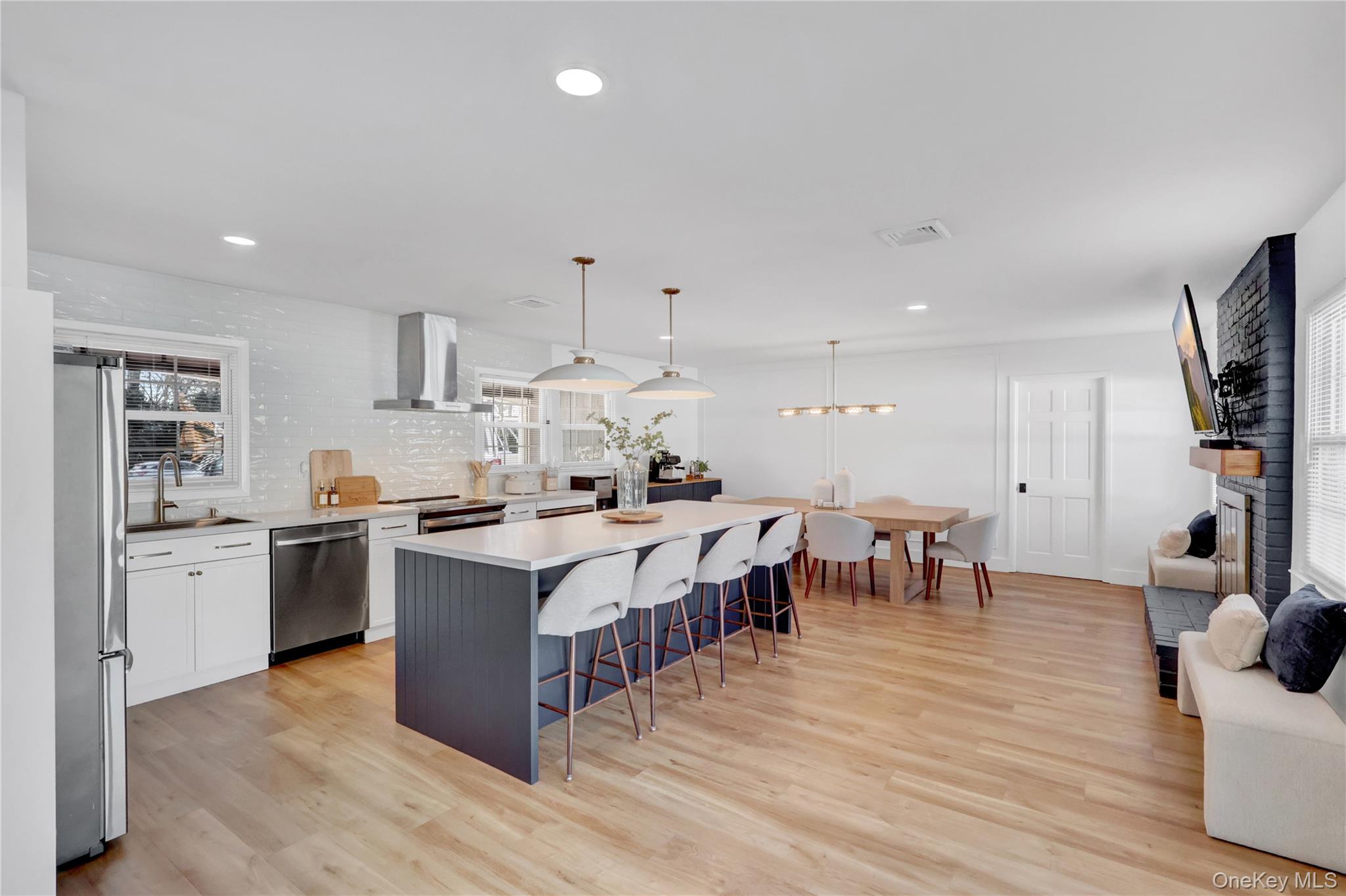 15 Whitmore Lane Coram, NY 11727 - Photo 4 of 10 a large white kitchen with stainless steel appliances