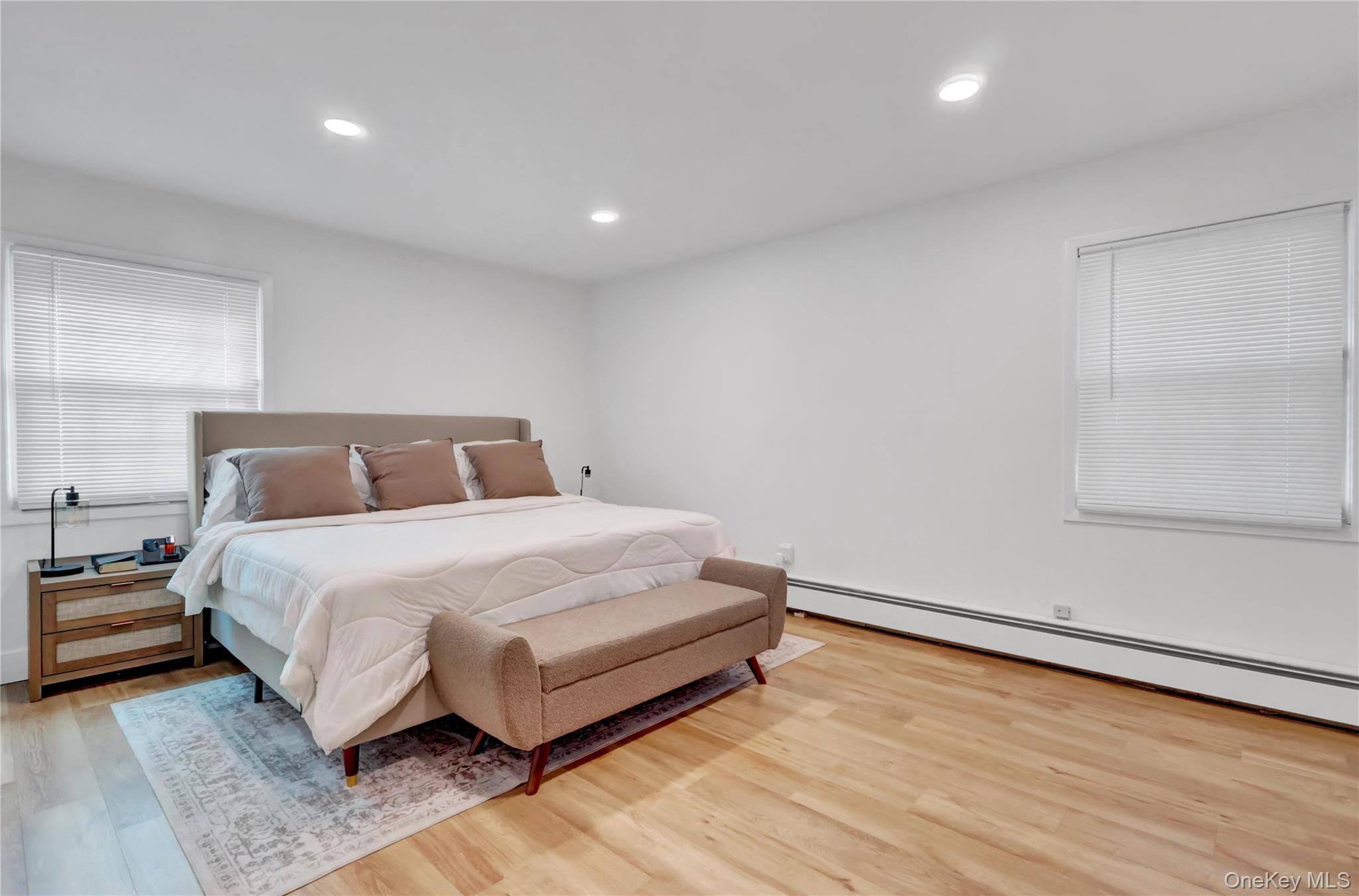 15 Whitmore Lane Coram, NY 11727 - Photo 6 of 10 a bedroom with a bed and a night stand