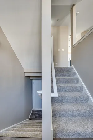 a view of staircase with white walls