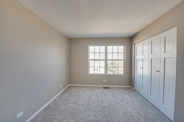 an empty room with a empty space and windows