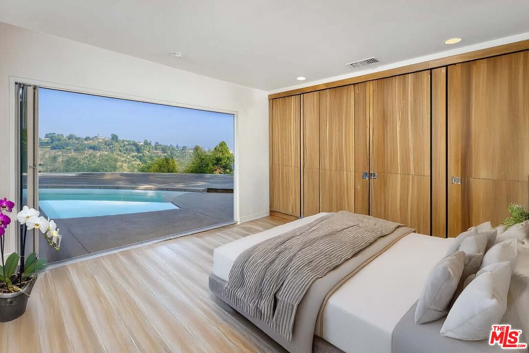 1000 Stradella Road Los Angeles, CA 90077 - Photo 11 of 29 a bedroom with a bed and a large window