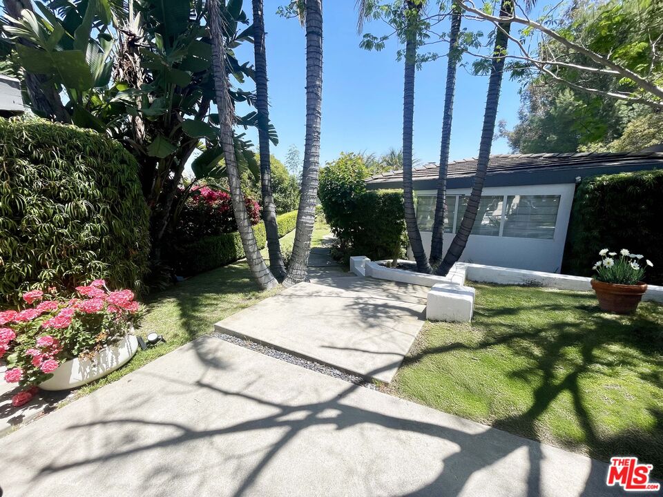 1000 Stradella Road Los Angeles, CA 90077 - Photo 9 of 29 a view of a white house with a yard and sitting area