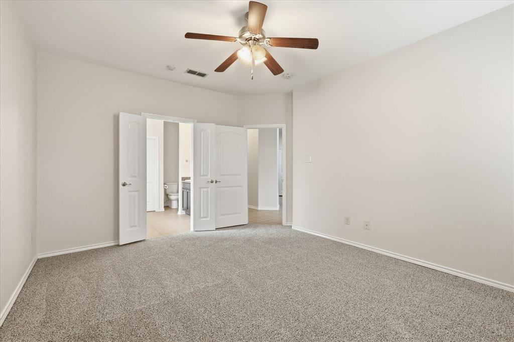 720 Rio Bravo Drive Fort Worth, TX 76052 - Photo 19 of 38 Spacious room featuring neutral carpeting, light-toned walls, and a ceiling fan with integrated lighting