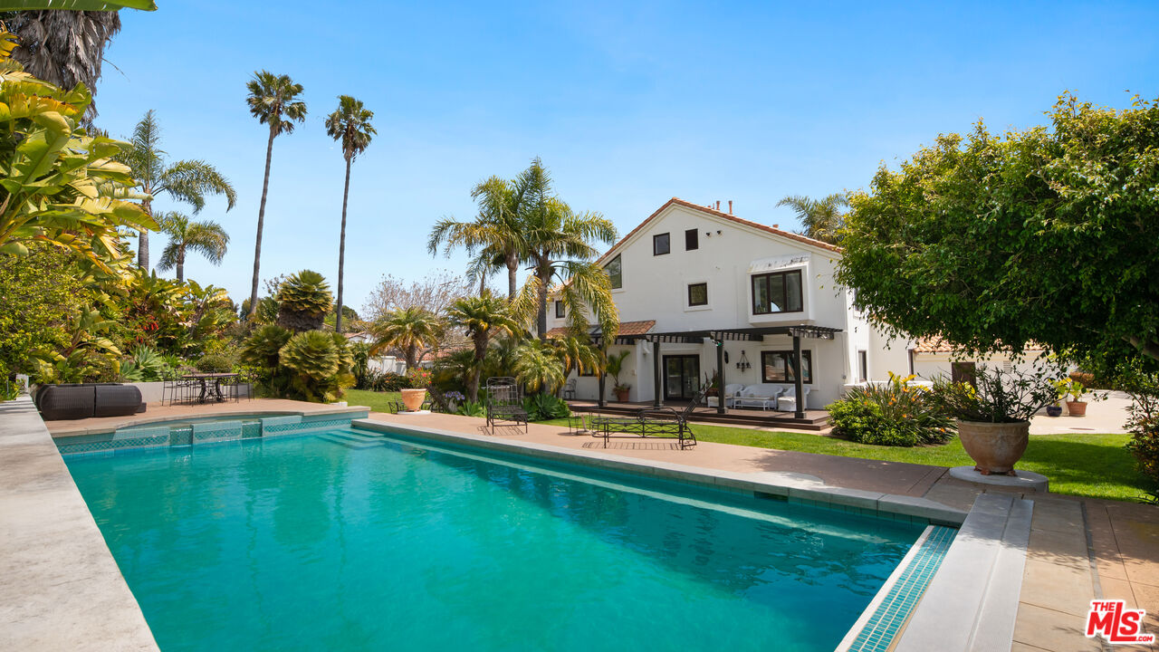 a view of a house with swimming pool and sitting area