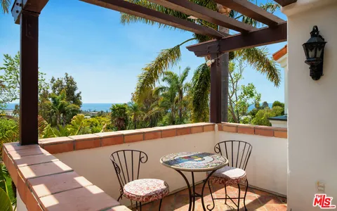 a view of a chair and table in patio
