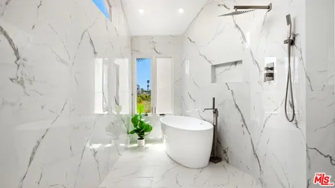 a white bath tub sitting in a bathroom