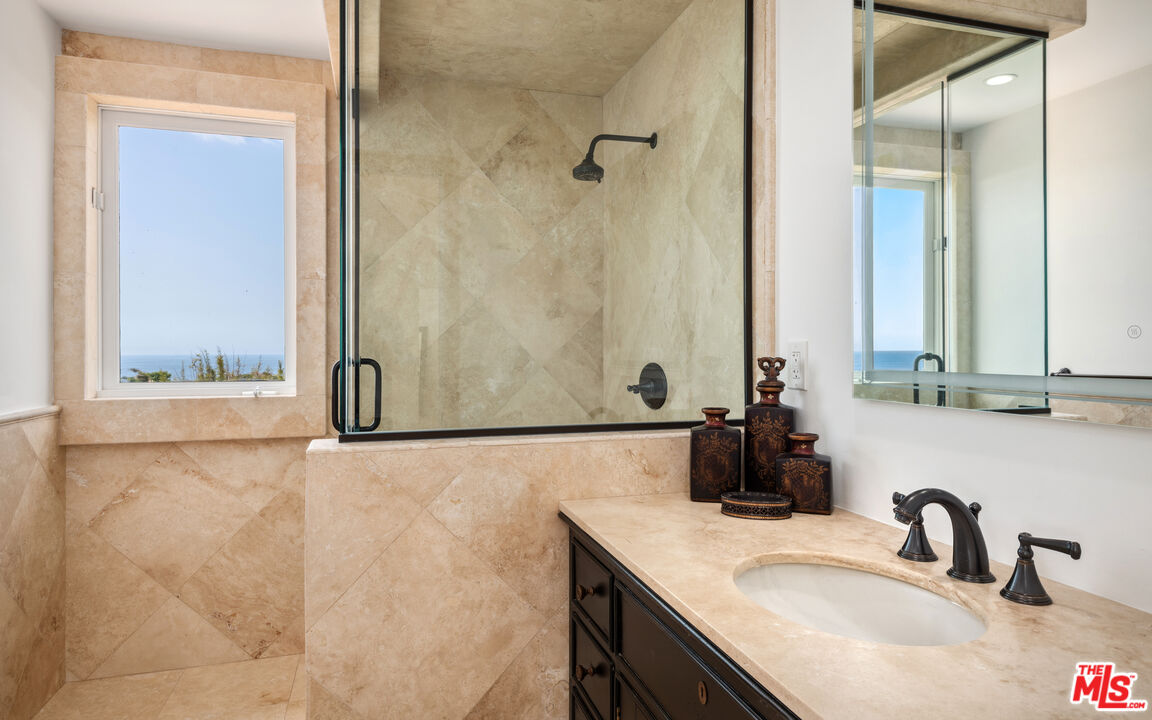 29675 Harvester Road Malibu, CA 90265 - Photo 25 of 36 a bathroom with a sink and a mirror