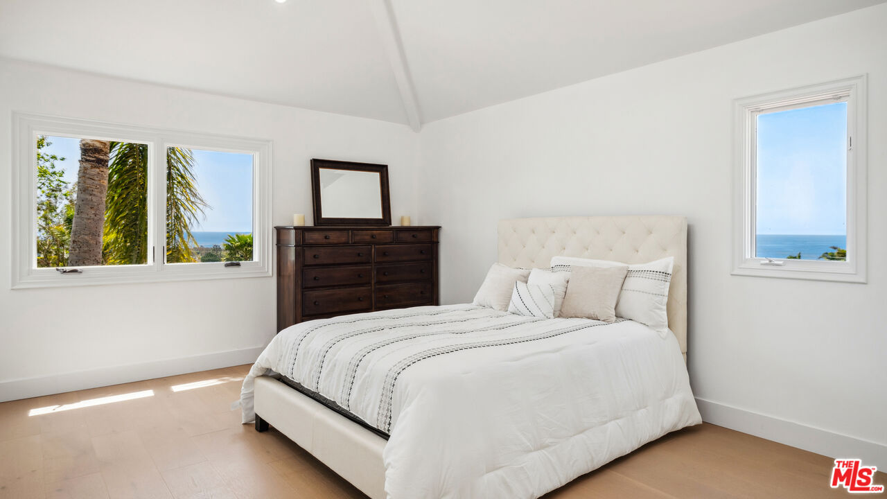 29675 Harvester Road Malibu, CA 90265 - Photo 26 of 36 a bedroom with a bed and a window