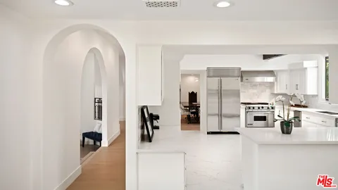 a view of kitchen with furniture and refrigerator