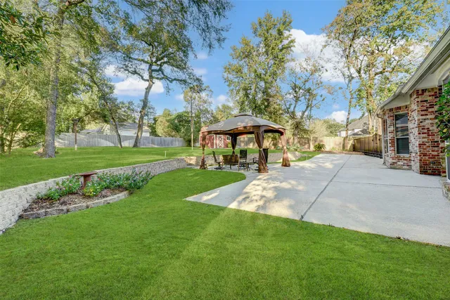 a view of a house with backyard and sitting area