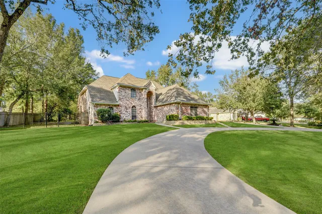a view of house with garden space and trees