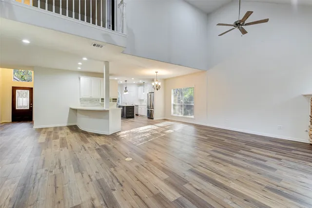 a view of a kitchen with cabinets and wooden floor