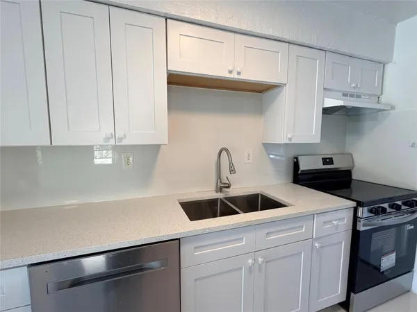 a kitchen with a sink and cabinets