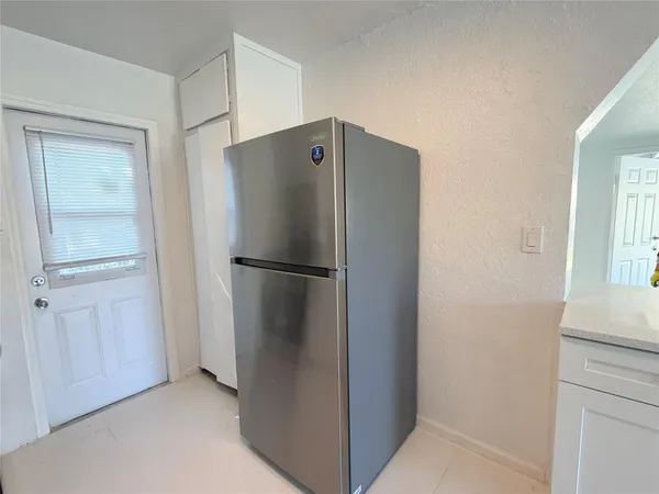 a refrigerator freezer sitting in a kitchen