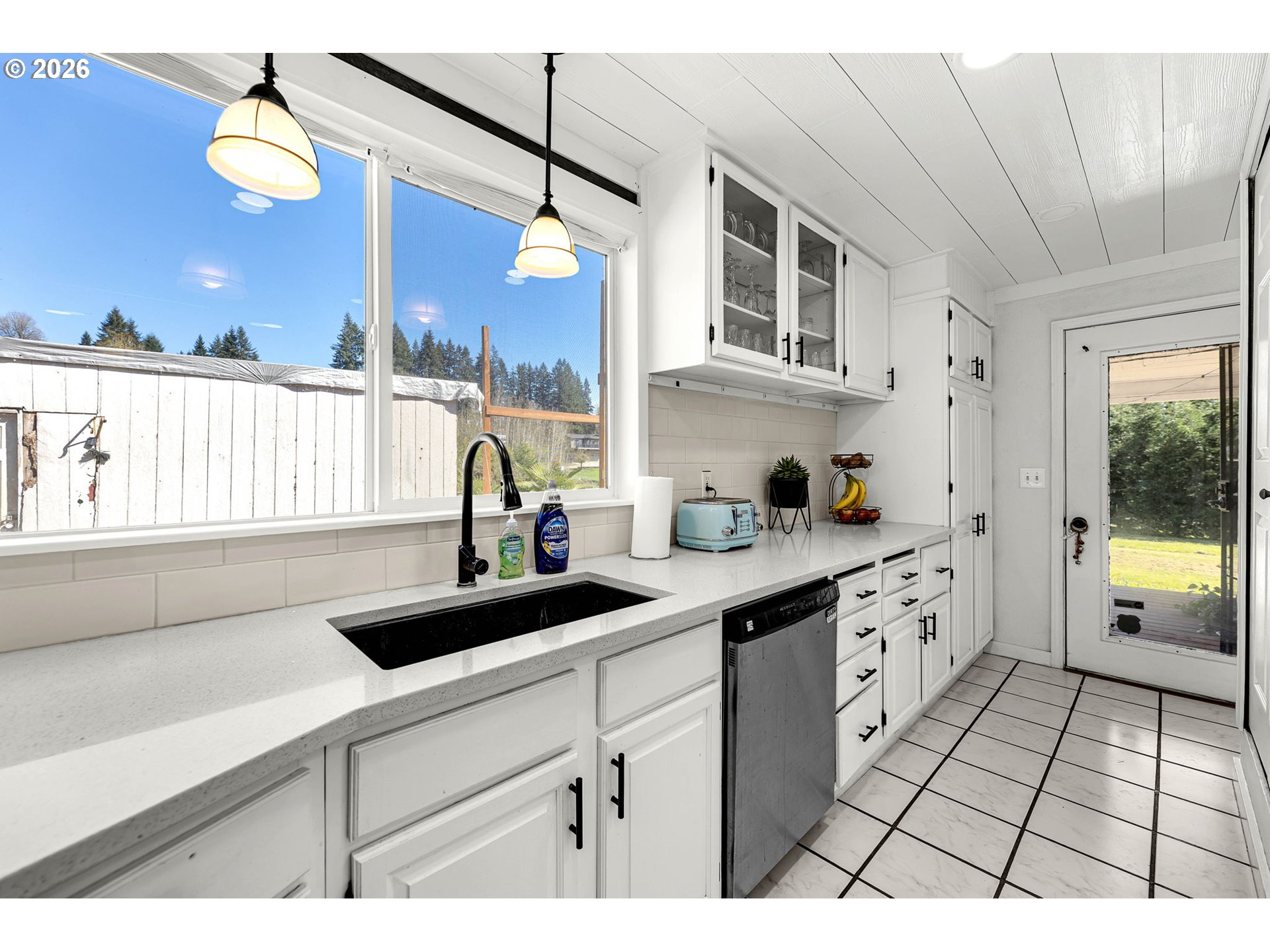 19905 Northeast 176th Avenue Battle Ground, WA 98604 - Photo 14 of 38 a kitchen with stainless steel appliances a sink a window and cabinets