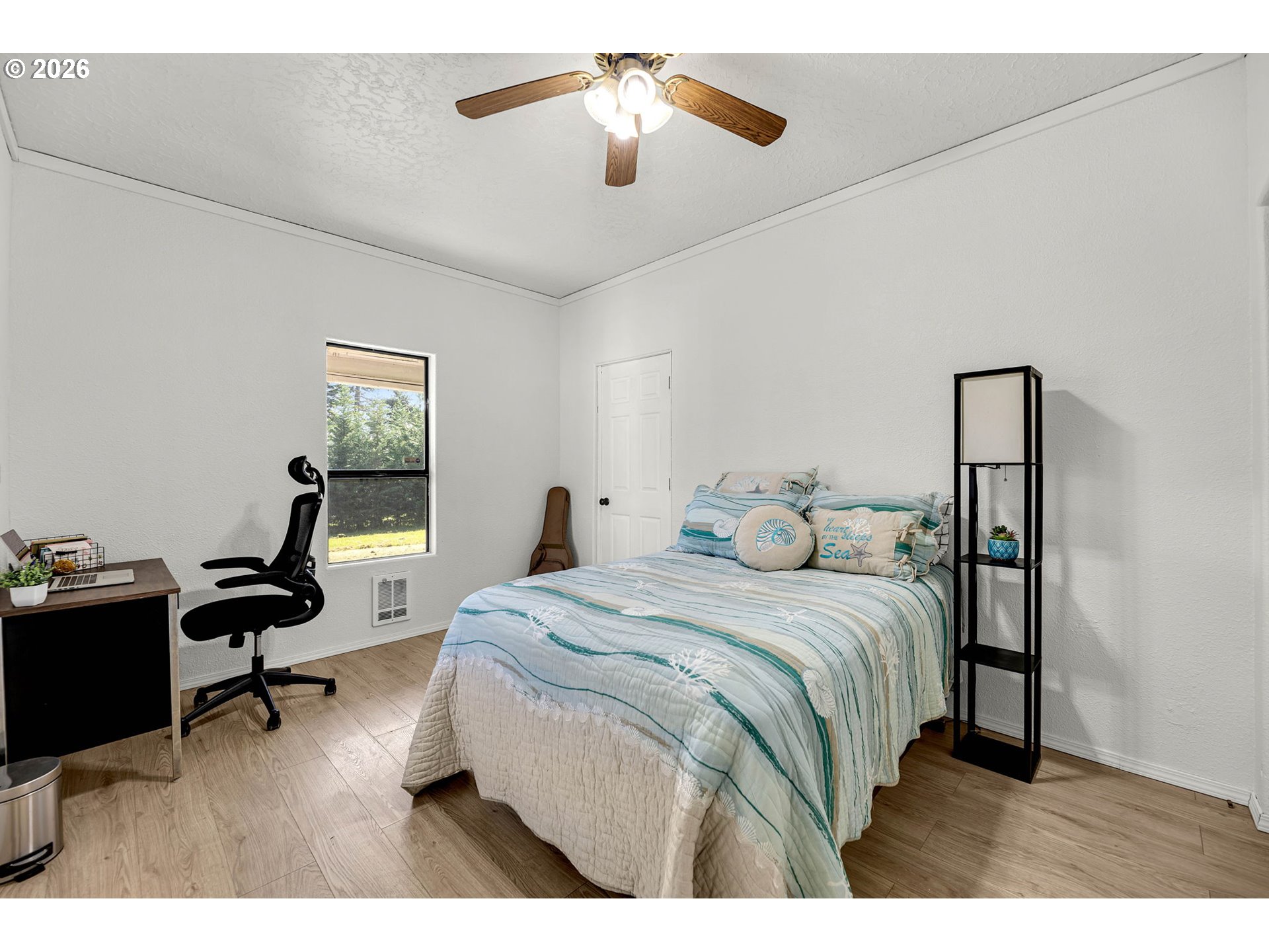 19905 Northeast 176th Avenue Battle Ground, WA 98604 - Photo 20 of 38 a bedroom with a bed and a chandelier