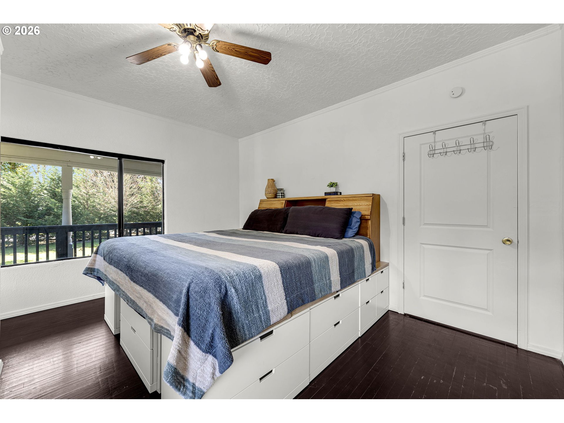 19905 Northeast 176th Avenue Battle Ground, WA 98604 - Photo 22 of 38 a bedroom with a large bed and a chandelier