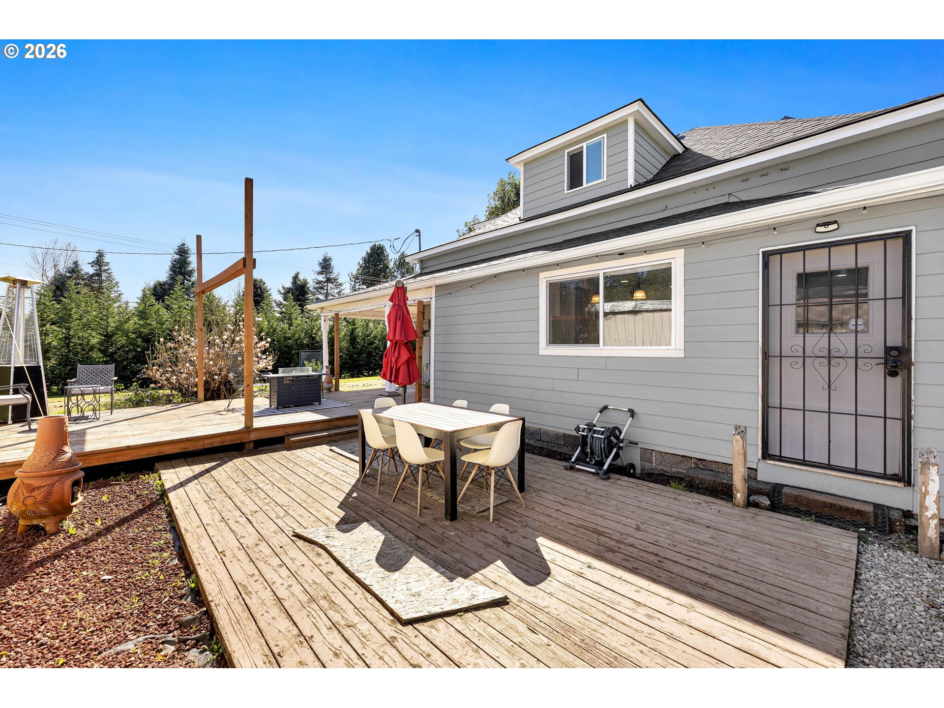 19905 Northeast 176th Avenue Battle Ground, WA 98604 - Photo 31 of 38 a view of a patio with couches table and chairs and potted plants