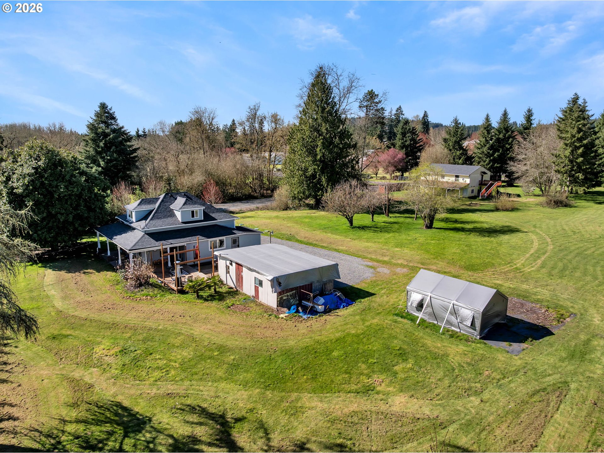 19905 Northeast 176th Avenue Battle Ground, WA 98604 - Photo 37 of 38 an aerial view of a house with swimming pool garden and trees