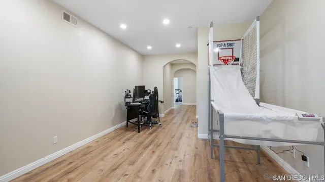 a view of entryway with workspace and wooden floor