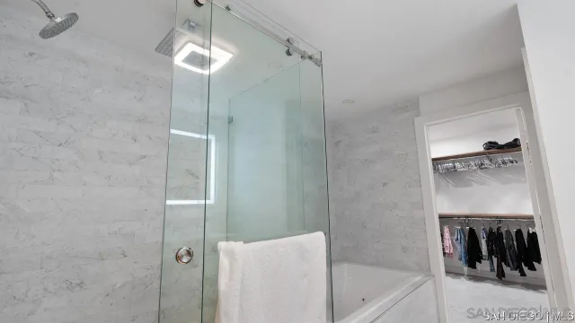 a bathroom with a tub and a shower