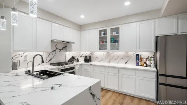 a kitchen with a sink a stove and refrigerator