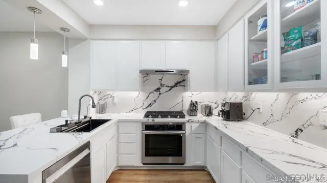 a kitchen with a sink and a stove top oven