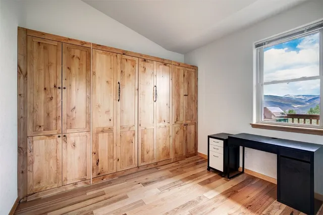 a view of a livingroom with wooden floor and windows