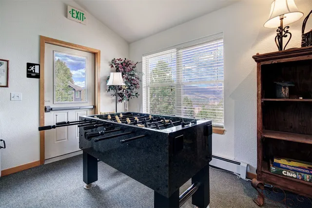 a view of a workspace with furniture and a window