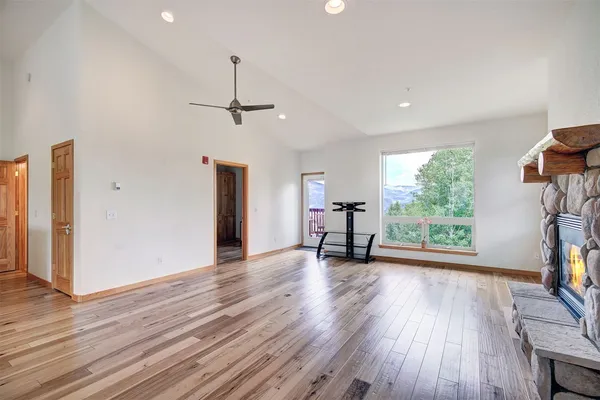 a view of empty room with wooden floor and outdoor view