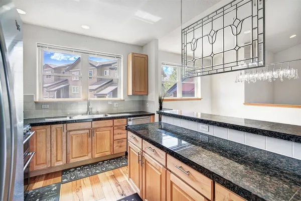 a kitchen with stainless steel appliances granite countertop a sink and a counter space