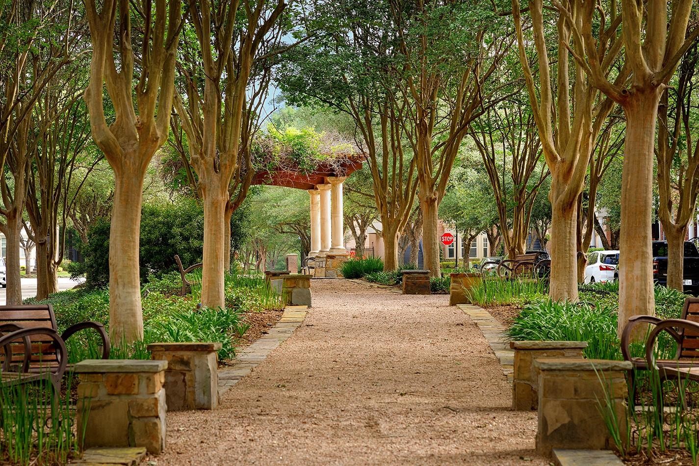2 Islewood Boulevard Spring, TX 77380 - Photo 37 of 48 Islewood Boulevard showcases a tree-lined path with benches and a pergola, offering a charming outdoor space ideal for relaxation and leisurely walks.