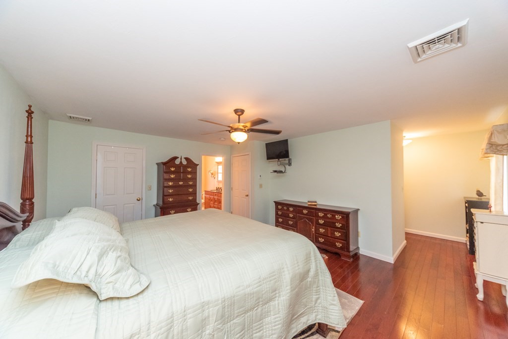 65 Williamsville Road Phillipston, MA 01331 - Photo 26 of 38 a bedroom with a bed dresser and a wooden floor