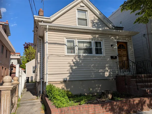 a view of a house with a yard and potted plants
