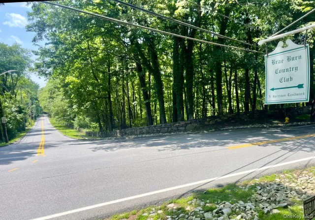 a view of a street with a building in the background