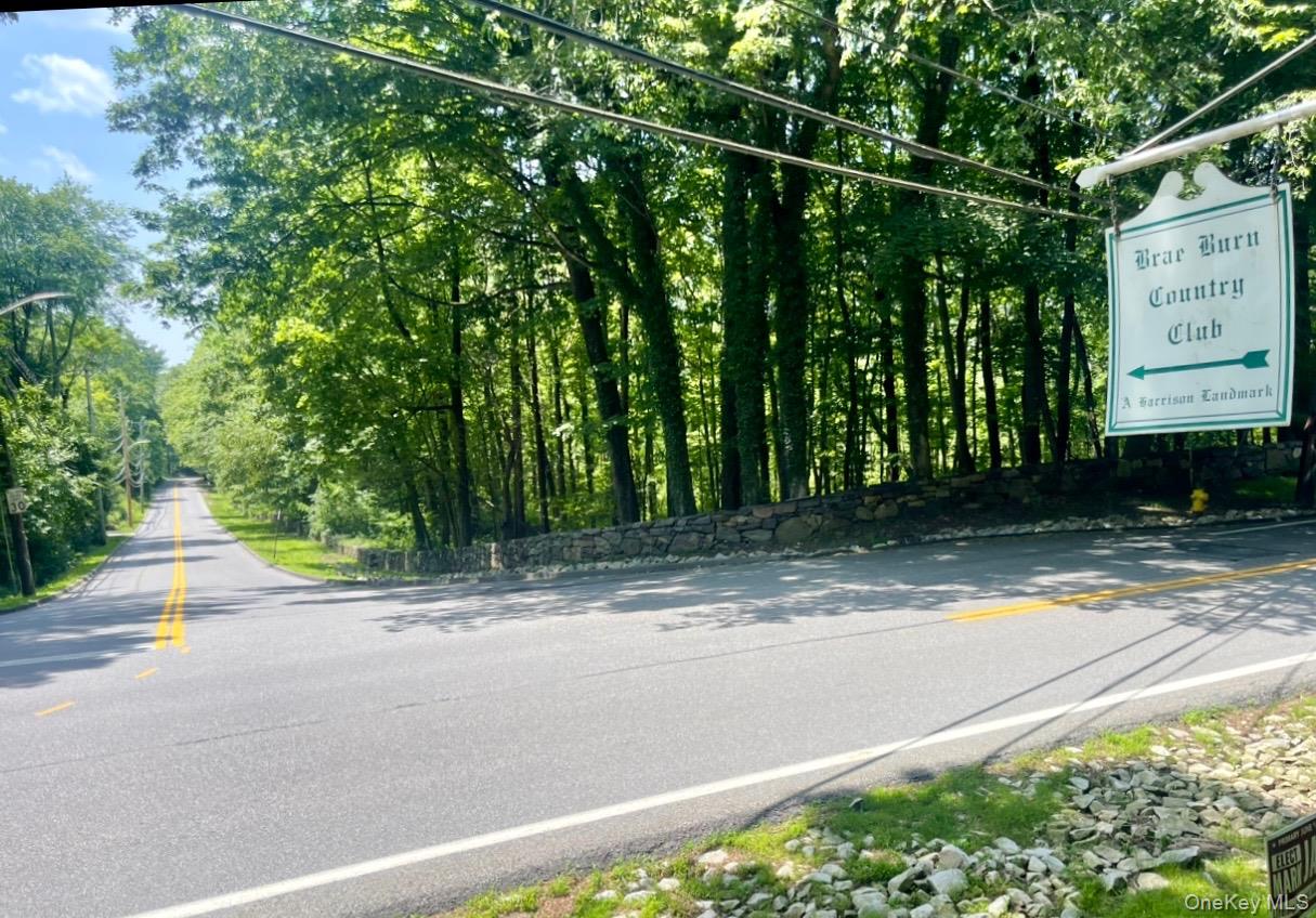 a view of a street with a building in the background