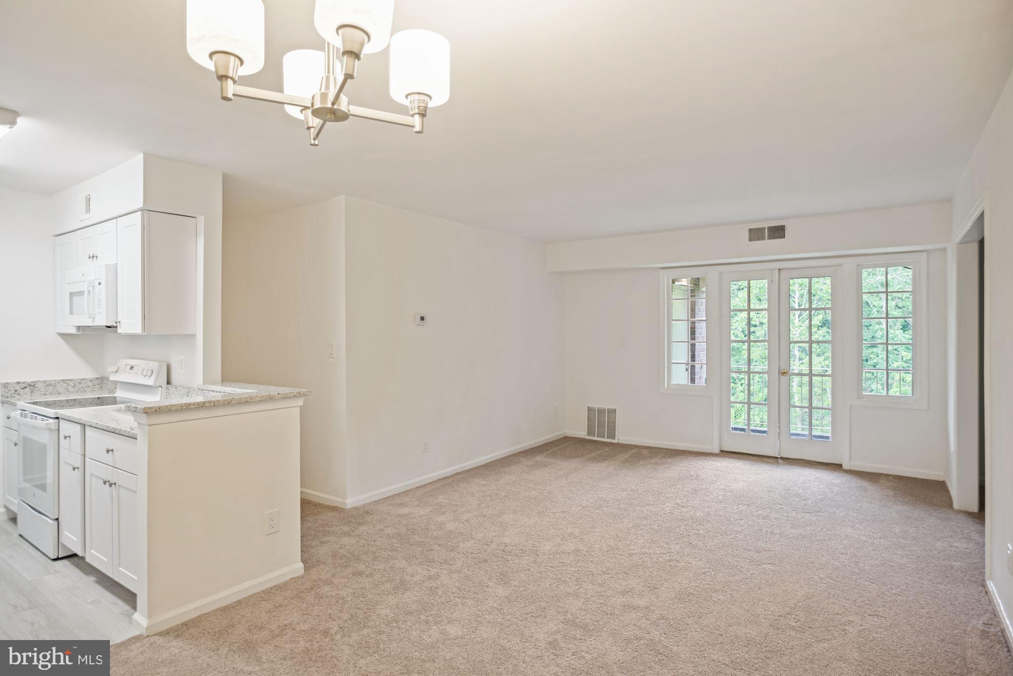 8112 Colony Point Road, Unit 231 Springfield, VA 22152 - Photo 8 of 30 Balcony doors to private lovely wooded view