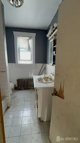 a bathroom with a sink toilet and mirror