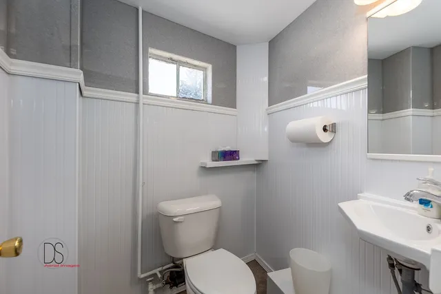 a white toilet sitting next to a bathroom sink