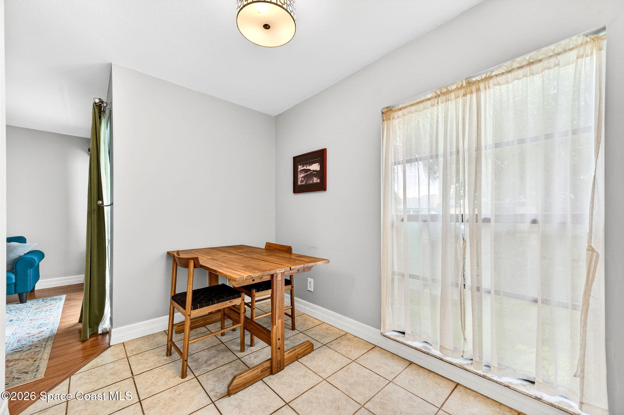 1225 North Wickham Road, Unit 422 Melbourne, FL 32935 - Photo 11 of 32 a view of a room that has a table and chair in it