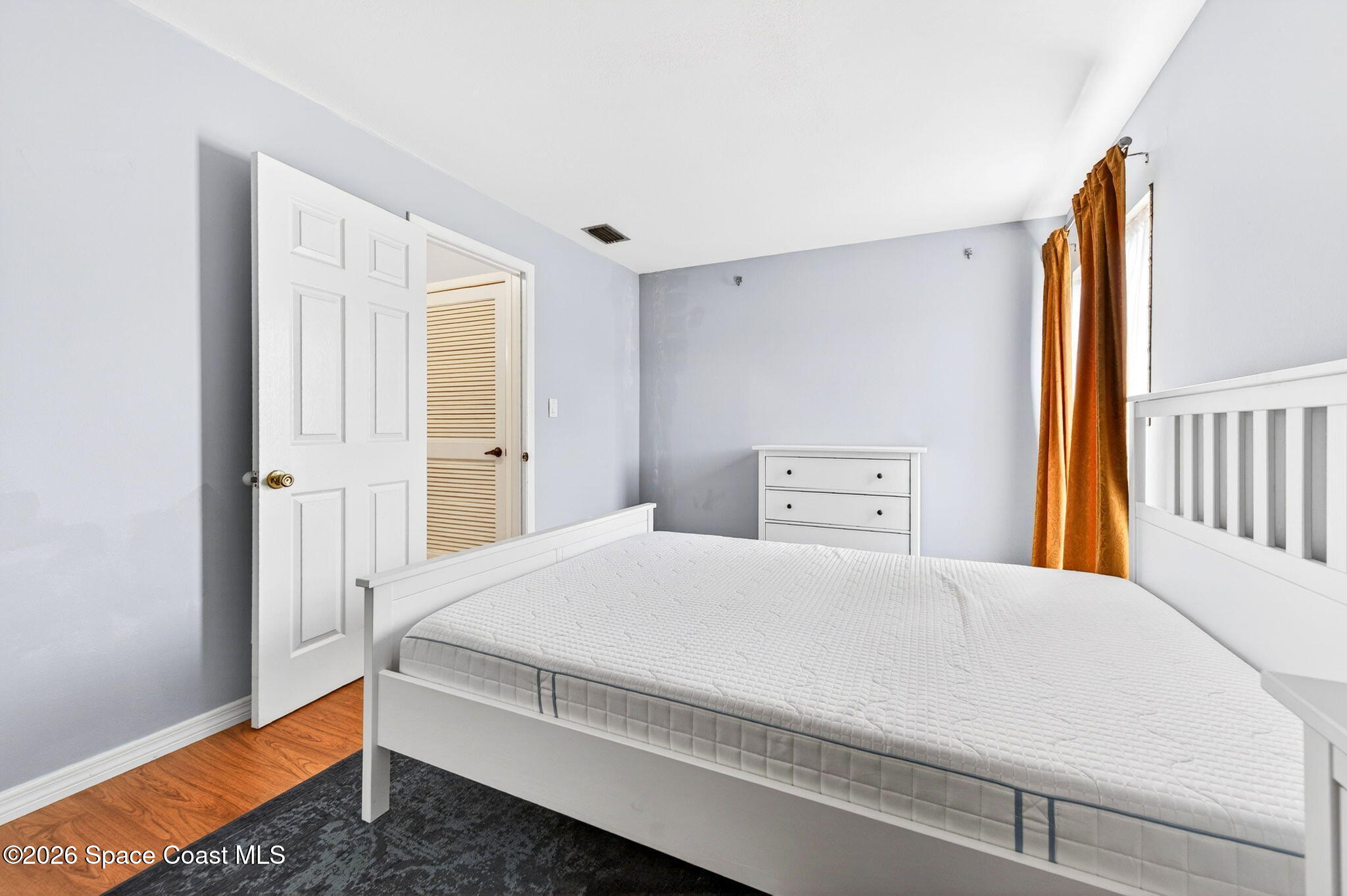 1225 North Wickham Road, Unit 422 Melbourne, FL 32935 - Photo 17 of 32 a bedroom with a bed and a window